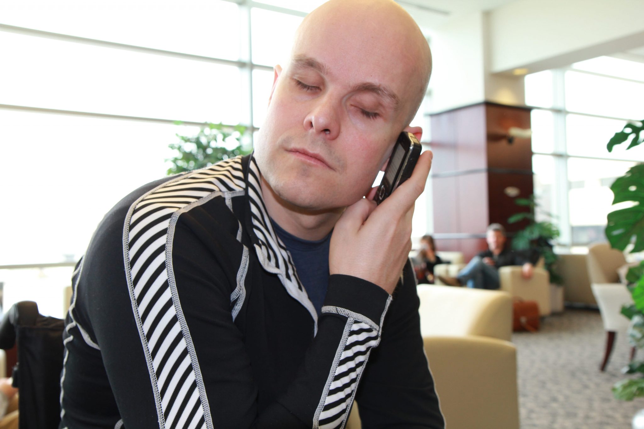 Mark Pollock holding a mobile telephone as he speaks to potential sponsors